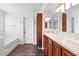 Bathroom with dual sinks, a bathtub and a shower at 7652 Borealis St, Las Vegas, NV 89123