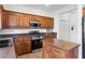 Bright kitchen with wooden cabinetry, stainless steel appliances, and center island at 7652 Borealis St, Las Vegas, NV 89123