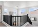 Upstairs loft with a dark wood railing and plenty of natural light at 7652 Borealis St, Las Vegas, NV 89123