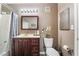 Bathroom with a wood vanity, framed mirror, and a tub and shower combination with a shower curtain at 7950 W Flamingo Rd # 1037, Las Vegas, NV 89147