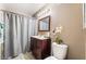 Bathroom with a wood vanity, framed mirror, and a tub and shower combination with a shower curtain at 7950 W Flamingo Rd # 1037, Las Vegas, NV 89147