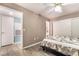 Bedroom features ceiling fan and sliding door closet, adjacent to a bathroom and laundry room at 7950 W Flamingo Rd # 1037, Las Vegas, NV 89147