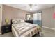 Bedroom with a queen bed with patterned bedding and features a ceiling fan and dresser at 7950 W Flamingo Rd # 1037, Las Vegas, NV 89147