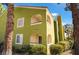 Condo exterior with private balconies overlooking lush landscaping and mature trees at 7950 W Flamingo Rd # 1037, Las Vegas, NV 89147