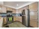 Well-lit kitchen features stainless steel appliances, light wood cabinets, and hard surface countertops at 7950 W Flamingo Rd # 1037, Las Vegas, NV 89147