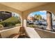 Relaxing balcony patio with a wooden table set and framed view of the parking lot and exterior at 7950 W Flamingo Rd # 1037, Las Vegas, NV 89147
