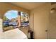Relaxing balcony patio with framed parking lot view and an adjacent apartment building entrance at 7950 W Flamingo Rd # 1037, Las Vegas, NV 89147