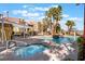 Community pool and spa area with lounge chairs and well-maintained landscaping on a sunny day at 7950 W Flamingo Rd # 1037, Las Vegas, NV 89147