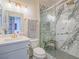 Stylish bathroom featuring a glass walk-in shower, modern vanity and marble tile at 817 Peachy Canyon Cir # 204, Las Vegas, NV 89144
