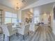 Open dining area with a glass table, comfortable seating, and modern lighting at 817 Peachy Canyon Cir # 204, Las Vegas, NV 89144