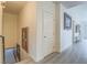 Hallway features artwork, neutral paint, and stairs leading to the lower level at 817 Peachy Canyon Cir # 204, Las Vegas, NV 89144