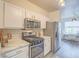 Modern kitchen featuring stainless steel appliances, granite countertops, and stylish cabinetry at 817 Peachy Canyon Cir # 204, Las Vegas, NV 89144