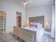 Bright bedroom with a tufted headboard, zebra rug, and an organized walk-in closet at 817 Peachy Canyon Cir # 204, Las Vegas, NV 89144