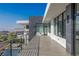 A long outdoor balcony with modern railings overlooks a pool and features views of the surrounding landscape at 9 Boulderback Dr, Henderson, NV 89012