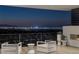 Relax on the balcony with an outdoor fireplace and seating, overlooking the spectacular city view at 9 Boulderback Dr, Henderson, NV 89012