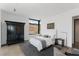 Bedroom with a neutral palette, wardrobe, and a large window offering pleasant views of the yard at 9 Boulderback Dr, Henderson, NV 89012