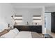 Modern bedroom wet bar with sleek black cabinetry, minimalist design, and open shelving at 9 Boulderback Dr, Henderson, NV 89012