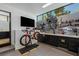 Organized bike room featuring custom storage solutions, a bicycle, a flat screen tv, and maintenance area at 9 Boulderback Dr, Henderson, NV 89012