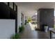 Covered outdoor walkway with desert landscaping and exterior television at 9 Boulderback Dr, Henderson, NV 89012