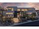 Striking contemporary home with illuminated landscaping, modern design, and inviting entrance at 9 Boulderback Dr, Henderson, NV 89012
