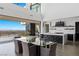 Modern kitchen and dining area with stunning city views and access to balcony at 9 Boulderback Dr, Henderson, NV 89012