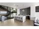 Open kitchen with a large island, bar seating, modern appliances, and staircase in view at 9 Boulderback Dr, Henderson, NV 89012