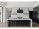 Contemporary kitchen showcasing a large island, sleek black cabinetry, and premium stainless steel appliances at 9 Boulderback Dr, Henderson, NV 89012