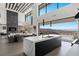 An open-concept kitchen features an island with a view of the outdoor living space and scenic mountain views at 9 Boulderback Dr, Henderson, NV 89012