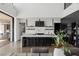 A modern, open-concept kitchen with a large island, sleek black cabinetry, and high-end appliances at 9 Boulderback Dr, Henderson, NV 89012
