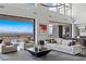 Bright open living room with city views, showcasing contemporary furniture and seamless indoor-outdoor flow at 9 Boulderback Dr, Henderson, NV 89012