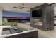 Relaxing outdoor area with a stunning city view, cozy furniture, and modern fireplace at 9 Boulderback Dr, Henderson, NV 89012