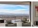 Comfortable seating areas with expansive windows provide stunning city views and access to a private pool at 9 Boulderback Dr, Henderson, NV 89012