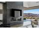 Open living room with fireplace, TV, and mountain views at 9 Boulderback Dr, Henderson, NV 89012