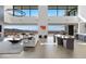 Bright, open-concept living and dining area with modern furnishings and stunning views of the city skyline at 9 Boulderback Dr, Henderson, NV 89012