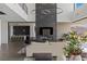 Spacious living room featuring fireplace, modern lighting, and open floor plan at 9 Boulderback Dr, Henderson, NV 89012