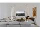 Cozy living room with a plush gray sectional, a large TV, and a round coffee table with a plant at 9 Boulderback Dr, Henderson, NV 89012