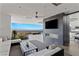 Modern living room featuring a linear fireplace, TV, comfortable seating, and expansive windows with city views at 9 Boulderback Dr, Henderson, NV 89012
