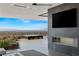 This modern living room highlights a fireplace with a mounted tv and an outside patio overlooking the city at 9 Boulderback Dr, Henderson, NV 89012
