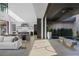 Open-concept living space with modern kitchen, dining area, and outdoor lounge at 9 Boulderback Dr, Henderson, NV 89012