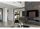 Open floor plan with a view of kitchen and fireplace with TV at 9 Boulderback Dr, Henderson, NV 89012