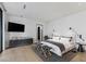 Bright main bedroom with a king bed, TV, modern furniture, and wood floors at 9 Boulderback Dr, Henderson, NV 89012