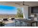 Outdoor kitchen and dining area with views of the mountains in the distance at 9 Boulderback Dr, Henderson, NV 89012