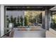 Covered outdoor patio featuring a seating area with lush landscaping at 9 Boulderback Dr, Henderson, NV 89012