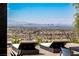 Serene poolside seating with panoramic views of the city skyline and surrounding mountains at 9 Boulderback Dr, Henderson, NV 89012