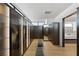 Large walk-in closet with built-in wood cabinets, and a mirror leading to a luxurious bathroom at 9 Boulderback Dr, Henderson, NV 89012