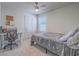 Bright bedroom features a ceiling fan, neutral walls, and a cozy carpet at 10279 Fragrant Apple Ct, Las Vegas, NV 89141