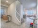 Inviting entryway featuring a staircase and view into an open-concept layout with tile flooring at 10279 Fragrant Apple Ct, Las Vegas, NV 89141