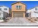 Two-story home featuring a brown stucco exterior, a two-car garage, and desert landscaping at 10279 Fragrant Apple Ct, Las Vegas, NV 89141