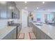 Modern kitchen featuring gray cabinetry, stainless steel appliances, and a large island with white countertop at 10279 Fragrant Apple Ct, Las Vegas, NV 89141