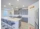 Spacious kitchen with a central island and breakfast bar, modern appliances, and stylish gray cabinetry at 10279 Fragrant Apple Ct, Las Vegas, NV 89141